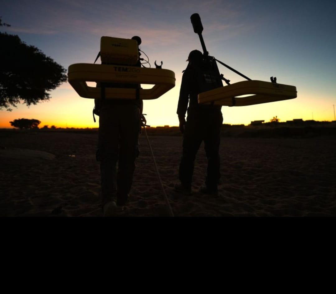 Geophysical survey team at sunset